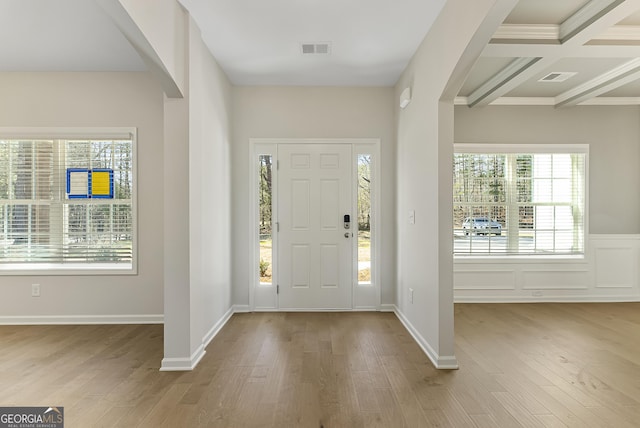 entrance foyer with coffered ceiling, light hardwood / wood-style flooring, and beam ceiling