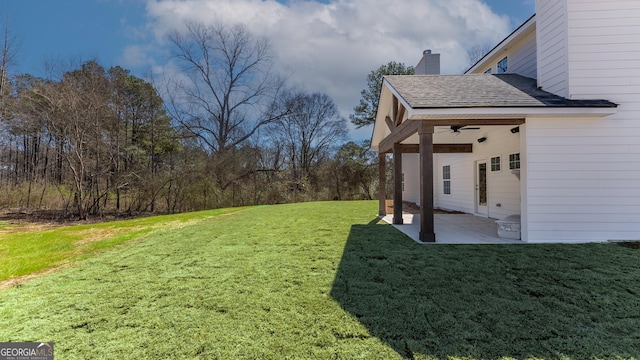 view of yard featuring a patio area and ceiling fan