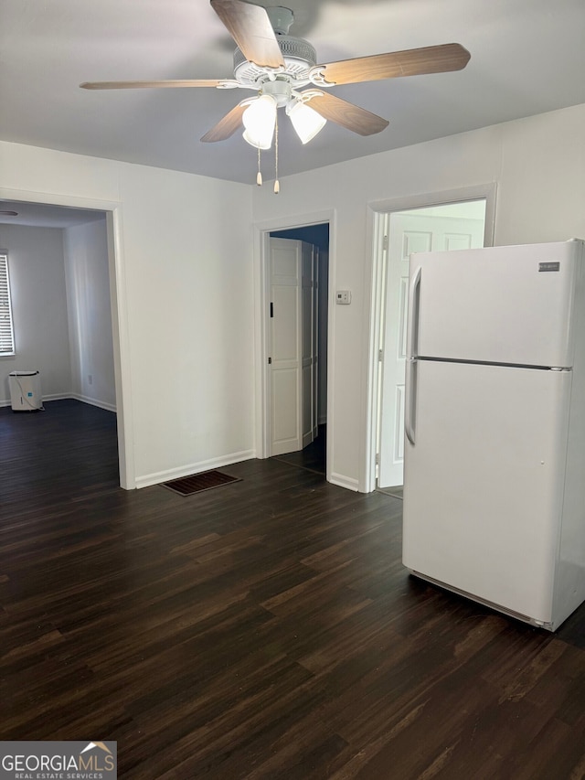 kitchen featuring ceiling fan, white fridge, and dark hardwood / wood-style floors