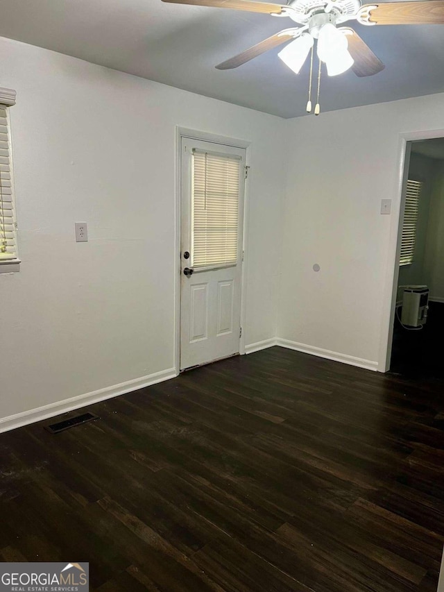 empty room featuring ceiling fan and dark hardwood / wood-style floors