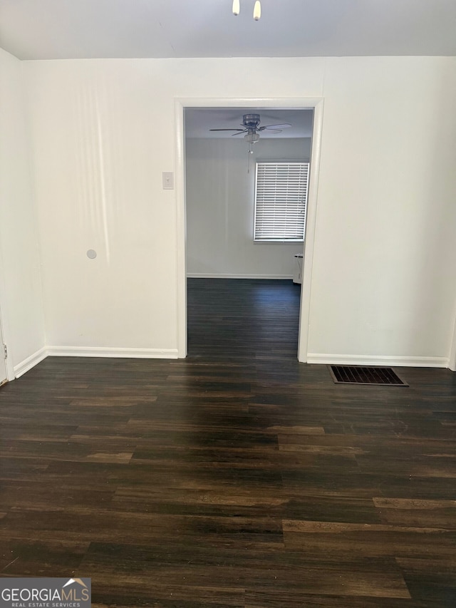 spare room featuring ceiling fan and dark hardwood / wood-style floors