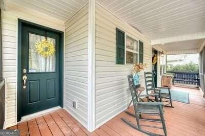 view of exterior entry with a porch