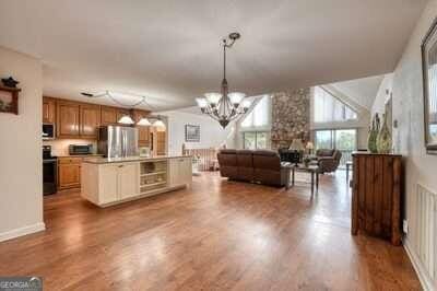 kitchen with stainless steel appliances, hardwood / wood-style floors, and a kitchen island