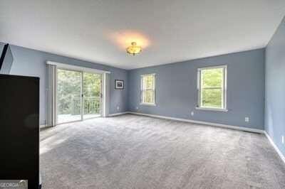 unfurnished living room featuring carpet flooring and a wealth of natural light