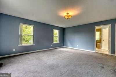 empty room with light colored carpet