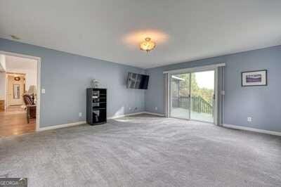 unfurnished living room featuring light colored carpet