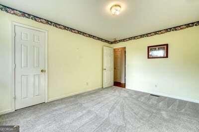 unfurnished bedroom with light carpet