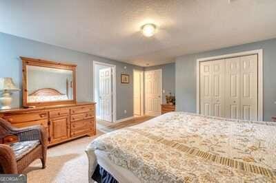 carpeted bedroom with a closet