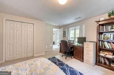 carpeted bedroom with a closet