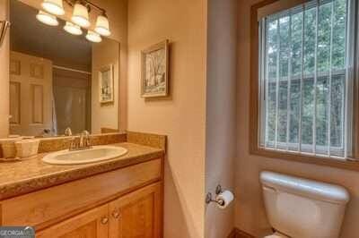 bathroom featuring vanity, toilet, and a wealth of natural light