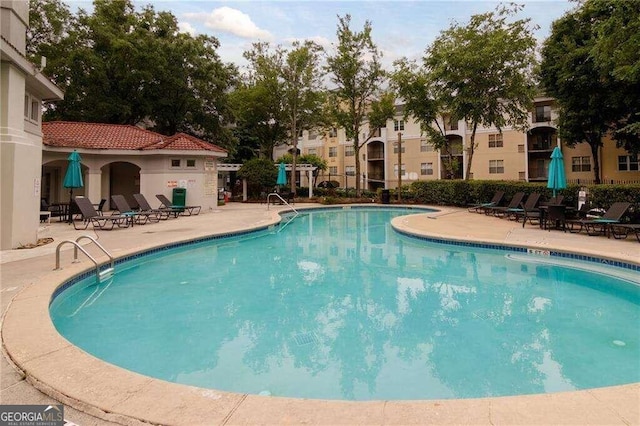 view of swimming pool with a patio area