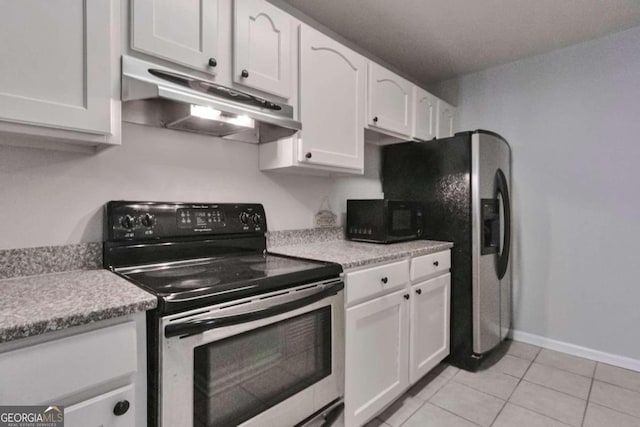 kitchen featuring appliances with stainless steel finishes, light tile patterned floors, and white cabinetry