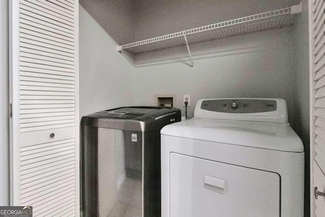 clothes washing area featuring separate washer and dryer