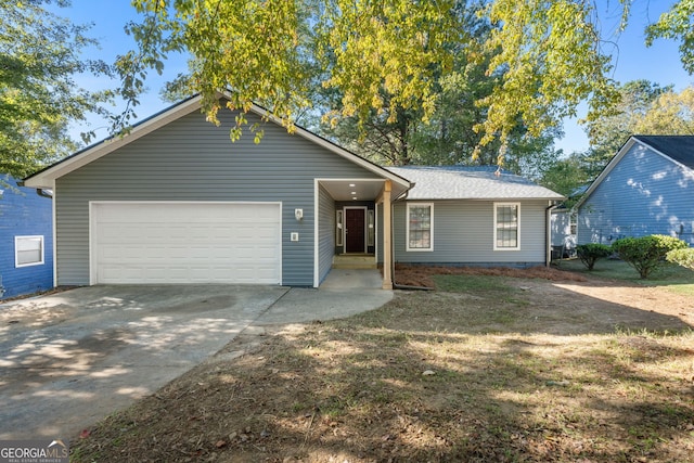 ranch-style house with a garage and concrete driveway