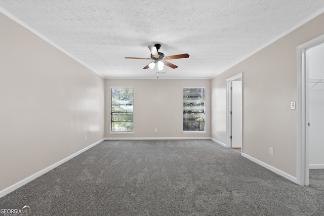 carpeted spare room featuring a textured ceiling, ceiling fan, ornamental molding, and baseboards