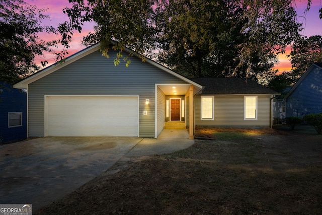 view of front of home with an attached garage and concrete driveway