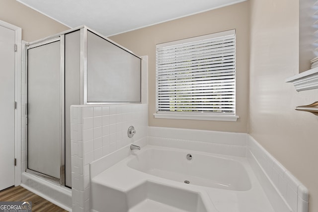 bathroom featuring shower with separate bathtub and hardwood / wood-style flooring