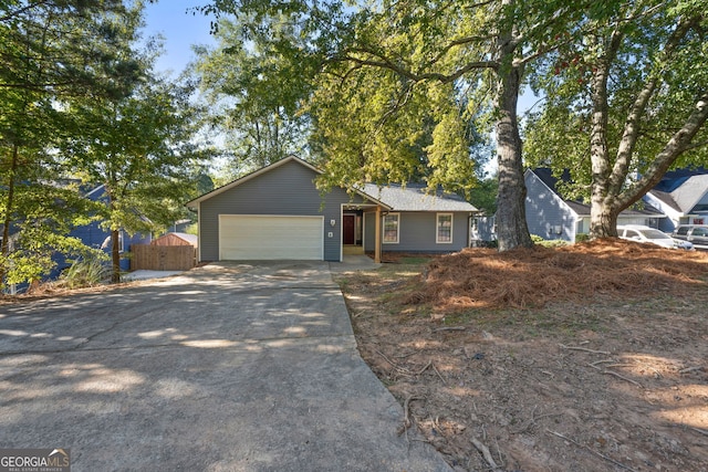 ranch-style home with concrete driveway and a garage
