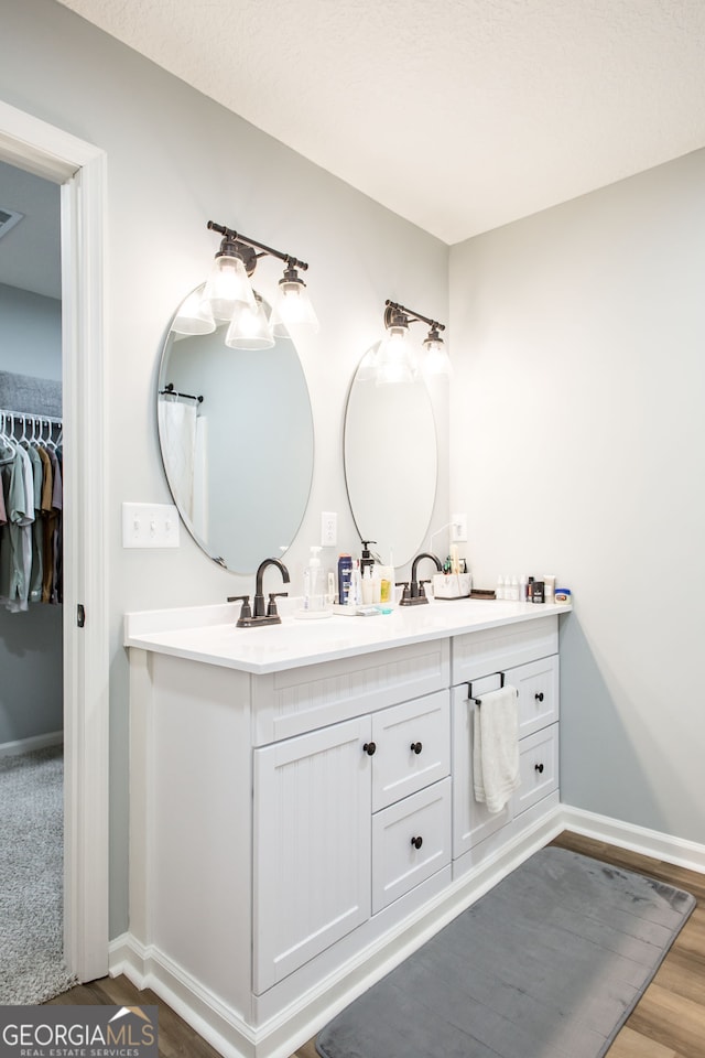 bathroom featuring hardwood / wood-style flooring and vanity