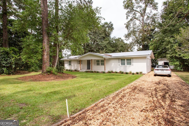 ranch-style home featuring a garage, a porch, and a front lawn