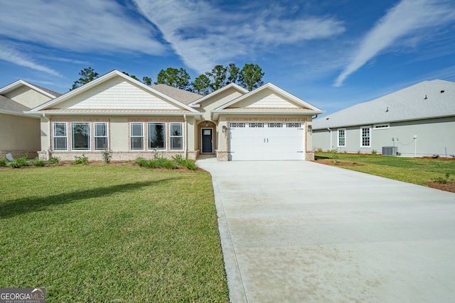 view of front of home featuring a garage, a front lawn, and central air condition unit