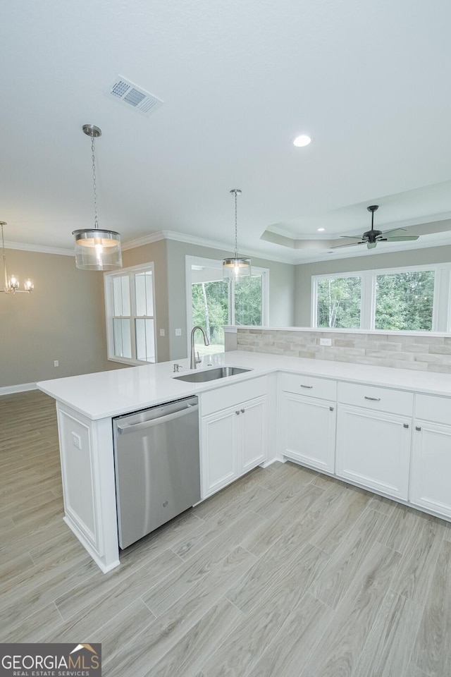245 Ryan Nicholas Dr, Kingsland, GA 31548 - kitchen featuring crown molding, a sink, dishwasher, light countertops, and visible vents
