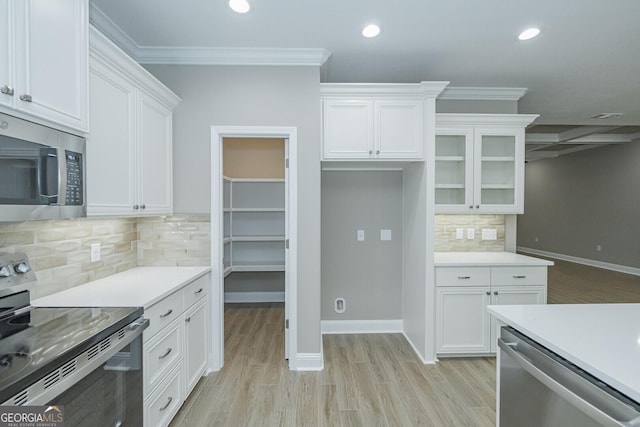245 Ryan Nicholas Dr, Kingsland, GA 31548 - kitchen with recessed lighting, light countertops, white cabinetry, and appliances with stainless steel finishes
