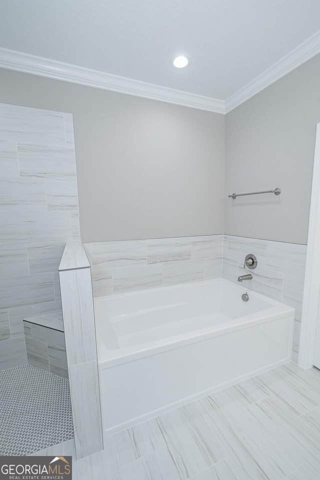 245 Ryan Nicholas Dr, Kingsland, GA 31548 - bathroom featuring recessed lighting, tile walls, ornamental molding, and a garden tub