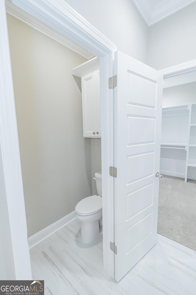 245 Ryan Nicholas Dr, Kingsland, GA 31548 - bathroom with toilet, baseboards, ornamental molding, and marble finish floor