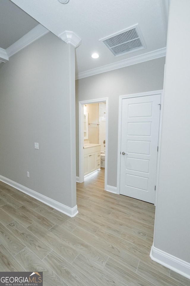 245 Ryan Nicholas Dr, Kingsland, GA 31548 - unfurnished room featuring crown molding, baseboards, visible vents, and light wood-type flooring