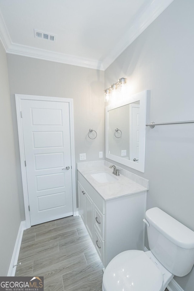 245 Ryan Nicholas Dr, Kingsland, GA 31548 - half bath featuring crown molding, toilet, visible vents, and vanity