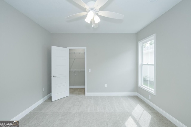 245 Ryan Nicholas Dr, Kingsland, GA 31548 - unfurnished bedroom with light carpet, a ceiling fan, baseboards, a spacious closet, and a closet