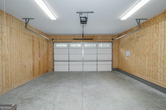245 Ryan Nicholas Dr, Kingsland, GA 31548 - garage featuring wooden walls and a garage door opener