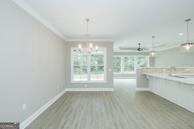 245 Ryan Nicholas Dr, Kingsland, GA 31548 - unfurnished dining area featuring ornamental molding, baseboards, light wood-type flooring, recessed lighting, and a sink