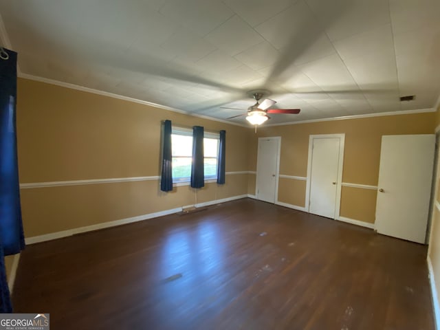 unfurnished bedroom with ceiling fan, dark hardwood / wood-style floors, and crown molding