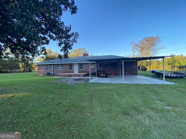 back of house featuring a yard and a carport