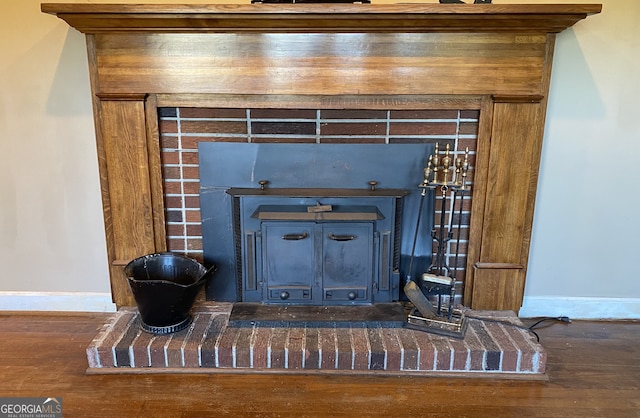 details with hardwood / wood-style flooring and a wood stove