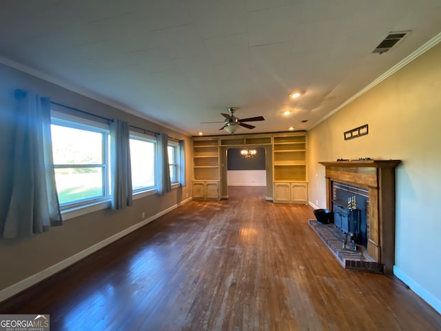 unfurnished living room with built in features, ceiling fan, dark hardwood / wood-style flooring, a fireplace, and ornamental molding