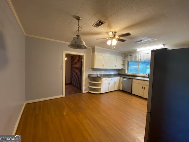 kitchen with white cabinets, sink, decorative light fixtures, appliances with stainless steel finishes, and light wood-type flooring