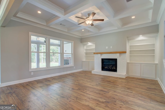 unfurnished living room featuring beamed ceiling, wood-type flooring, and coffered ceiling