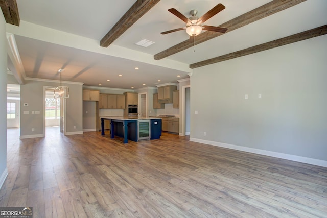 kitchen with a breakfast bar, beam ceiling, light hardwood / wood-style flooring, a center island, and hanging light fixtures