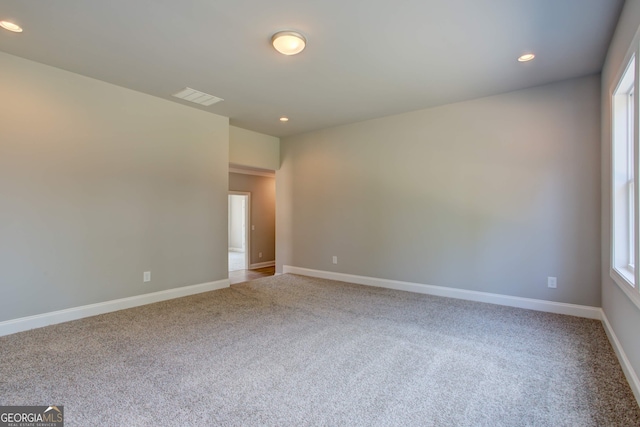 carpeted spare room with plenty of natural light