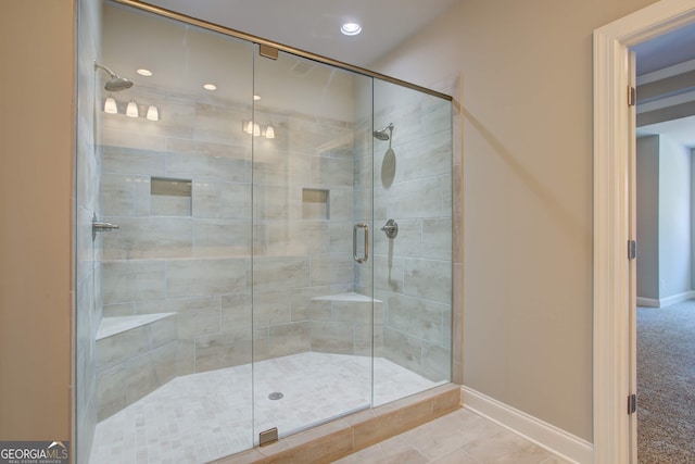 bathroom featuring tile patterned floors and a shower with door