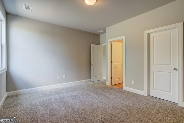 unfurnished bedroom with light colored carpet