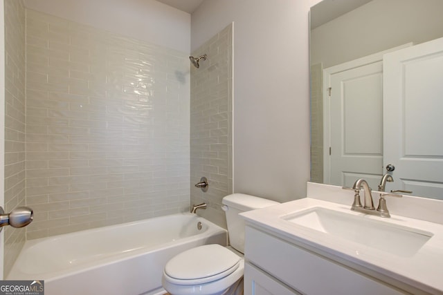 full bathroom with tiled shower / bath combo, toilet, and vanity