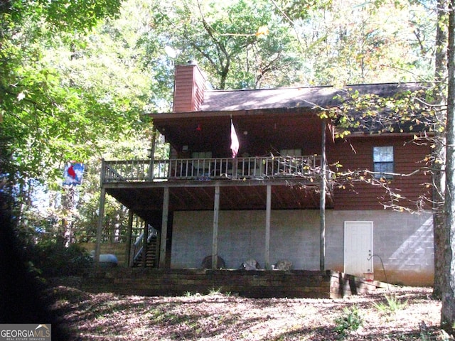 back of property featuring a wooden deck