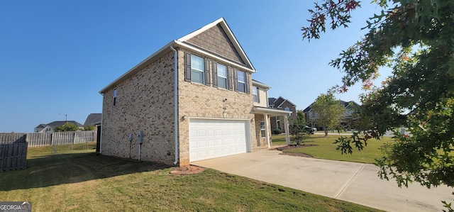 view of side of property with brick siding, fence, concrete driveway, a yard, and a garage