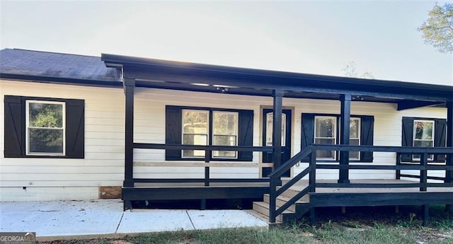 back of property with covered porch