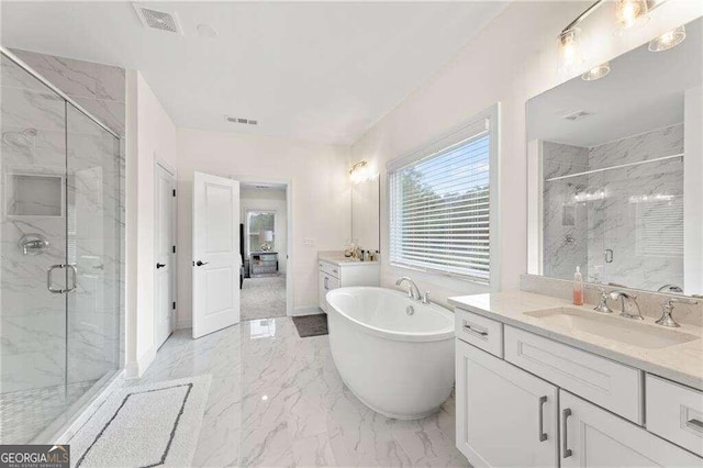 bathroom featuring vanity and independent shower and bath