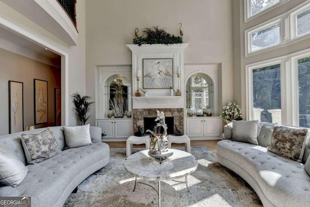 living room with a fireplace, a high ceiling, and hardwood / wood-style floors